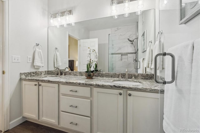 2945 W Riverwalk Cir Unit B, Littleton, CO 80123 - full bathroom with double vanity, a stall shower, and baseboards
