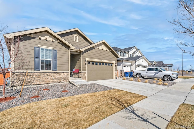 view of front of home featuring concrete driveway, a garage, and stone siding