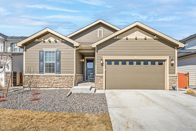 craftsman house with stone siding, concrete driveway, and an attached garage