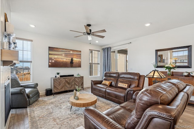 living room with recessed lighting, baseboards, and wood finished floors