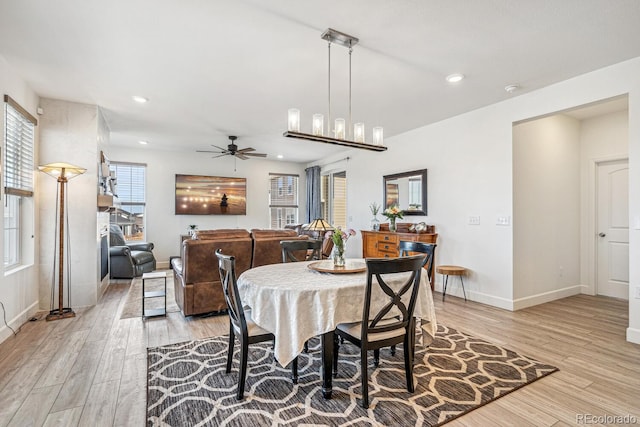 dining room with a ceiling fan, recessed lighting, light wood-style floors, and baseboards