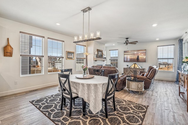 dining space with recessed lighting, baseboards, and light wood-type flooring