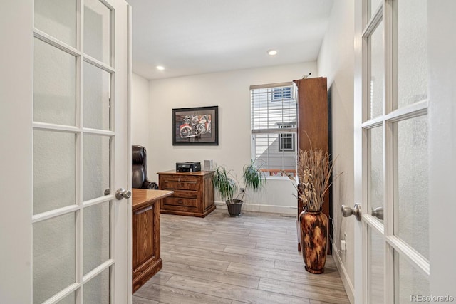 hallway with light wood-style flooring, recessed lighting, french doors, and baseboards