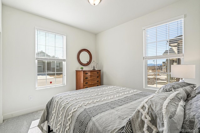 carpeted bedroom with baseboards