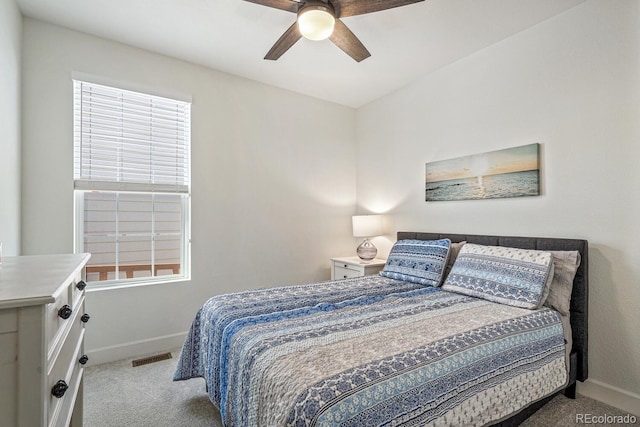 carpeted bedroom featuring visible vents, a ceiling fan, and baseboards