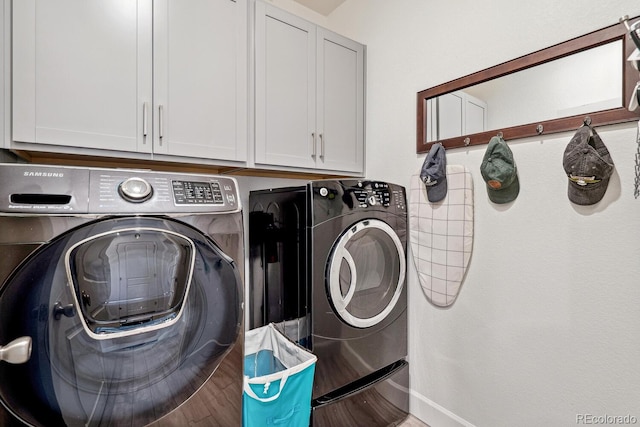 laundry room with washer and clothes dryer, cabinet space, and baseboards