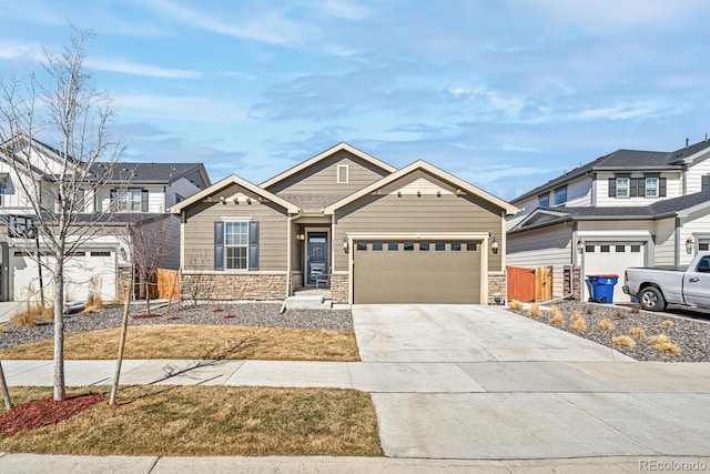 view of front of house featuring concrete driveway, an attached garage, fence, and stone siding