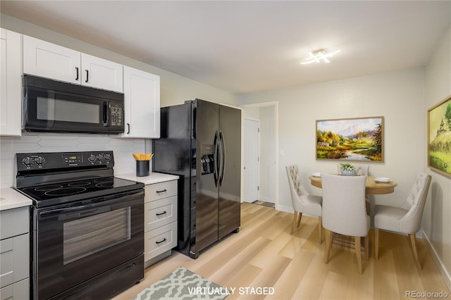 740 Lotus Way, Broomfield, CO 80020 - kitchen featuring black appliances, light wood-style floors, light countertops, and decorative backsplash