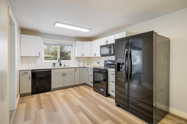 740 Lotus Way, Broomfield, CO 80020 - kitchen featuring black appliances, a sink, backsplash, and light wood finished floors