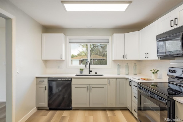 740 Lotus Way, Broomfield, CO 80020 - kitchen featuring black appliances, a sink, backsplash, light wood-style floors, and light countertops