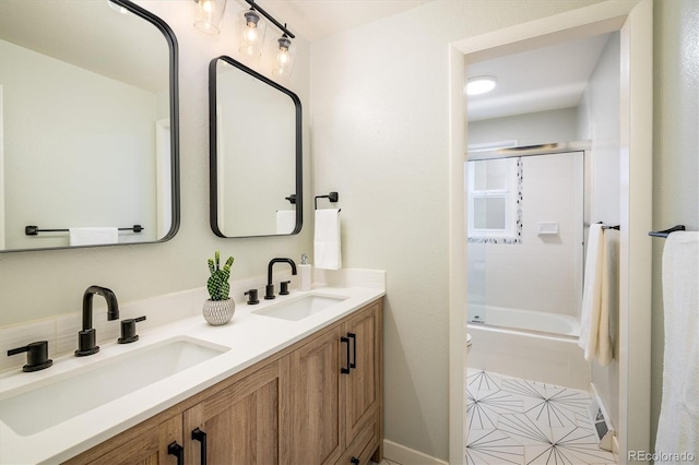 740 Lotus Way, Broomfield, CO 80020 - full bathroom featuring double vanity, shower / bath combination with glass door, and toilet