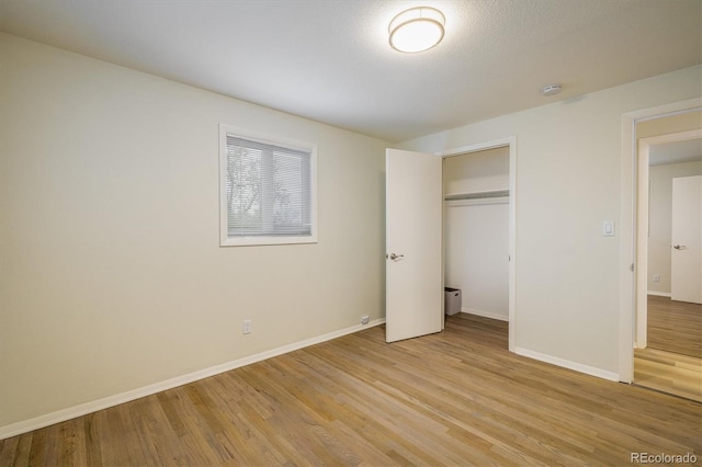 740 Lotus Way, Broomfield, CO 80020 - unfurnished bedroom with light wood-style floors, baseboards, and a closet