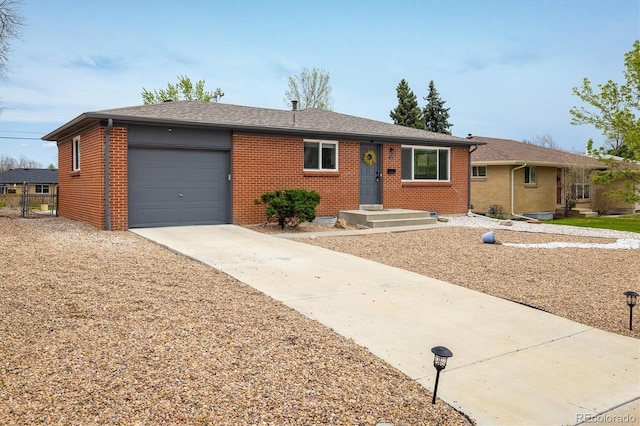 740 Lotus Way, Broomfield, CO 80020 - ranch-style house with brick siding, an attached garage, driveway, and a shingled roof
