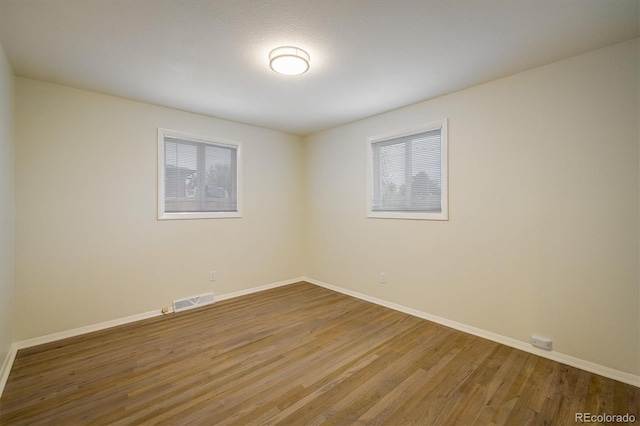 740 Lotus Way, Broomfield, CO 80020 - unfurnished room with wood finished floors and baseboards