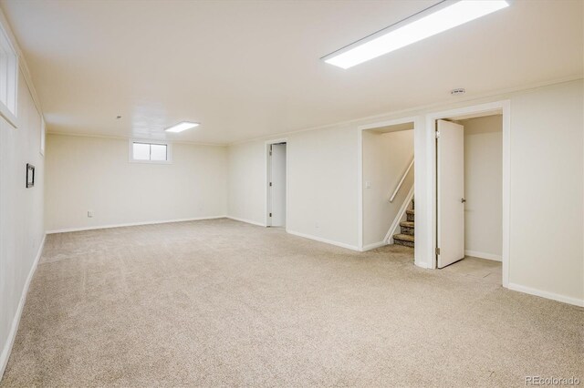 740 Lotus Way, Broomfield, CO 80020 - below grade area with light carpet, stairs, and baseboards