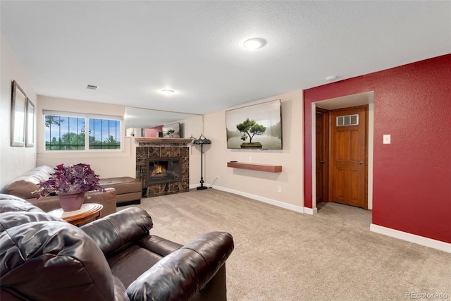 6798 Depew St, Arvada, CO 80003 - living area with a textured wall, carpet floors, a stone fireplace, and a textured ceiling