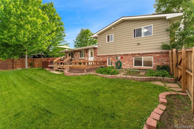 6798 Depew St, Arvada, CO 80003 - rear view of property featuring a deck, a fenced backyard, and brick siding
