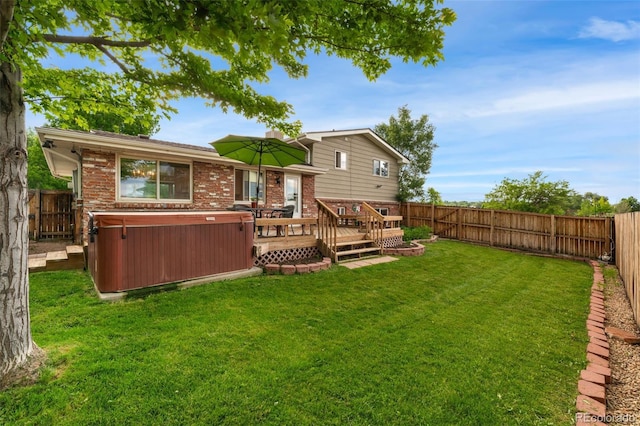 6798 Depew St, Arvada, CO 80003 - rear view of property featuring a hot tub, a fenced backyard, and a wooden deck