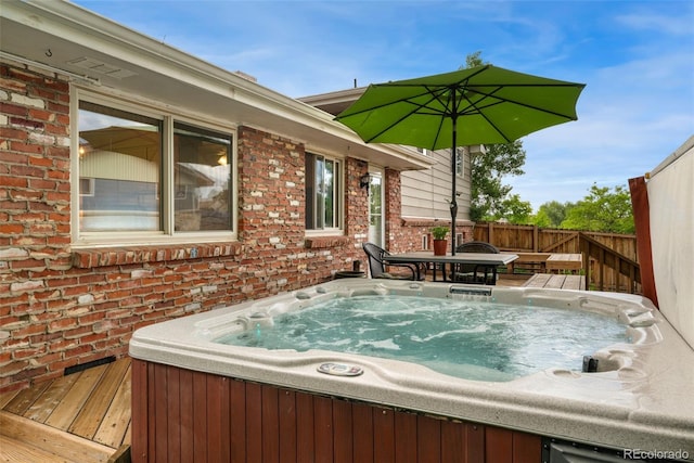 6798 Depew St, Arvada, CO 80003 - wooden deck with a hot tub and outdoor dining area