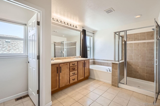 7838 W Layton Way, Littleton, CO 80123 - full bath featuring a stall shower, a garden tub, healthy amount of natural light, and tile patterned flooring