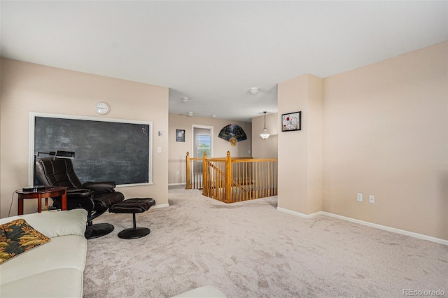 living area featuring baseboards and carpet flooring