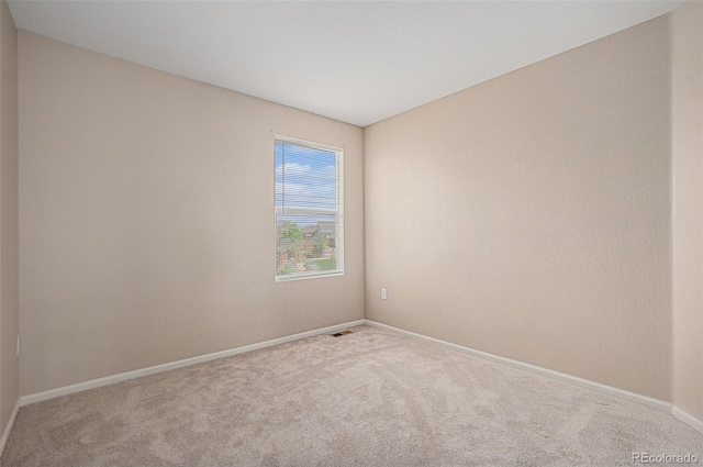 unfurnished room with baseboards and carpet flooring