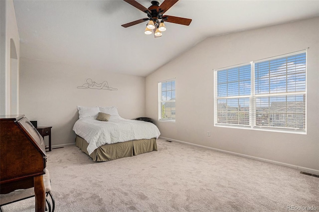 carpeted bedroom with visible vents, a ceiling fan, baseboards, and vaulted ceiling