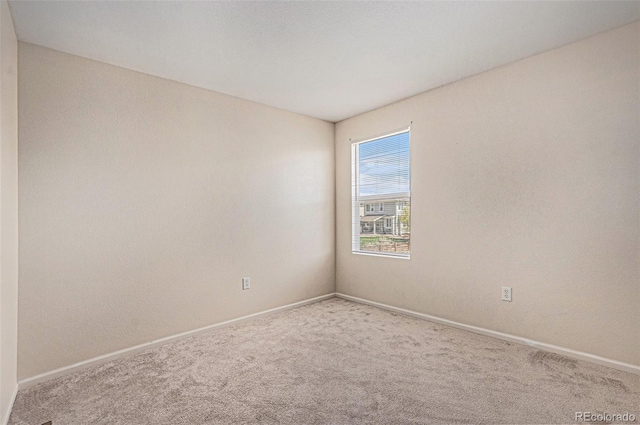 spare room with carpet floors and baseboards