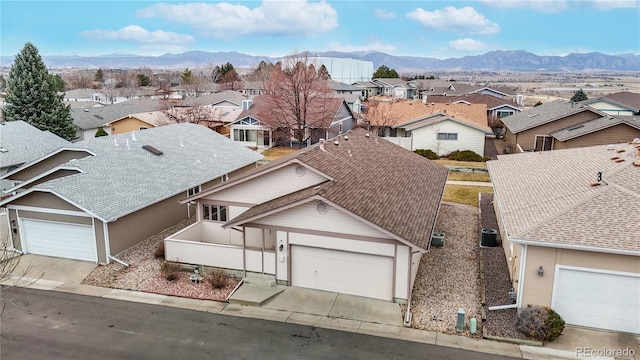 exterior space featuring a residential view, concrete driveway, and a mountain view