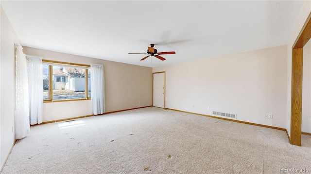 empty room with baseboards, visible vents, and carpet flooring