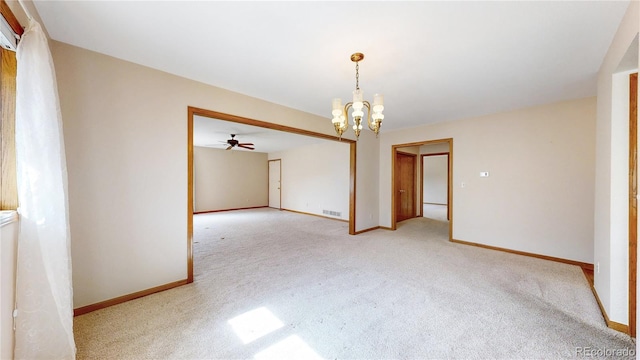 spare room featuring baseboards, visible vents, a chandelier, and light colored carpet