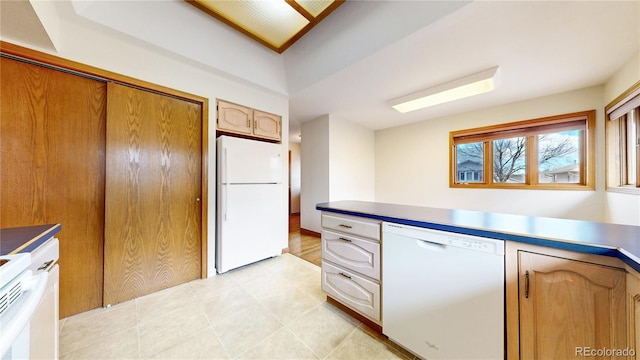 kitchen with white appliances and light tile patterned flooring