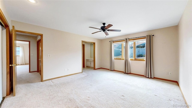 empty room with light carpet, ceiling fan, and baseboards