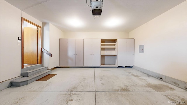 garage with baseboards and a garage door opener