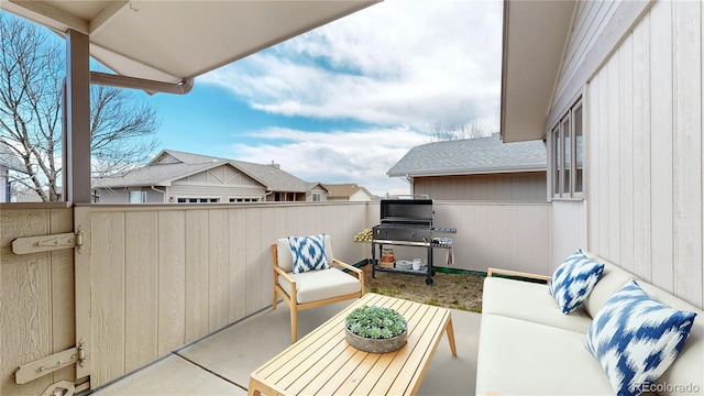 view of patio / terrace with a balcony, grilling area, and an outdoor living space