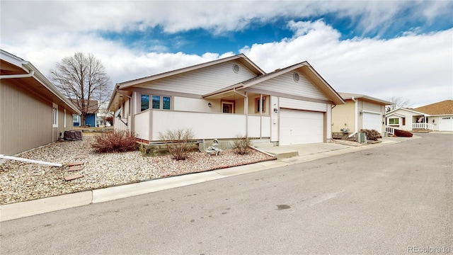 view of front of home with concrete driveway and an attached garage