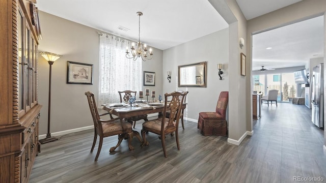 dining area featuring a chandelier and dark hardwood / wood-style flooring