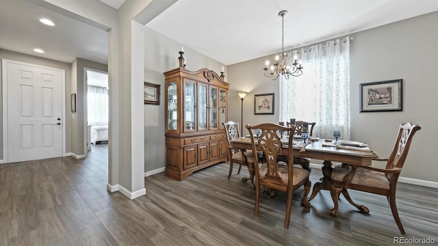 dining room with a healthy amount of sunlight, a chandelier, and dark hardwood / wood-style floors