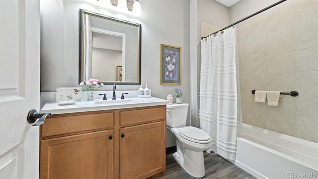 full bathroom featuring hardwood / wood-style floors, toilet, vanity, and shower / tub combo with curtain