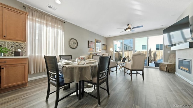 dining room with ceiling fan and wood-type flooring