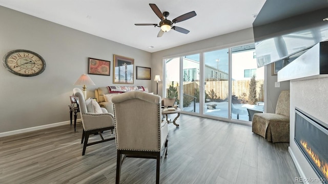 living room featuring ceiling fan and wood-type flooring