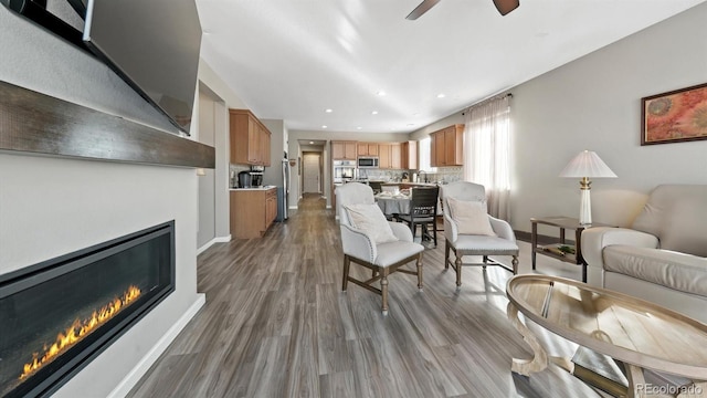 living room with hardwood / wood-style flooring and ceiling fan