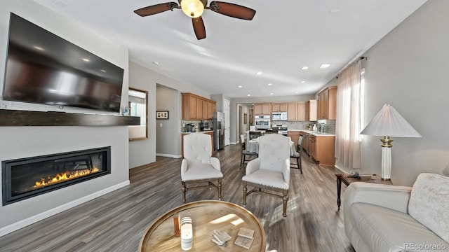 living room with hardwood / wood-style flooring and ceiling fan