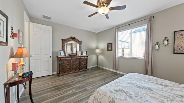 bedroom with ceiling fan and dark wood-type flooring