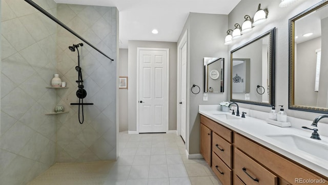 bathroom featuring a tile shower and vanity