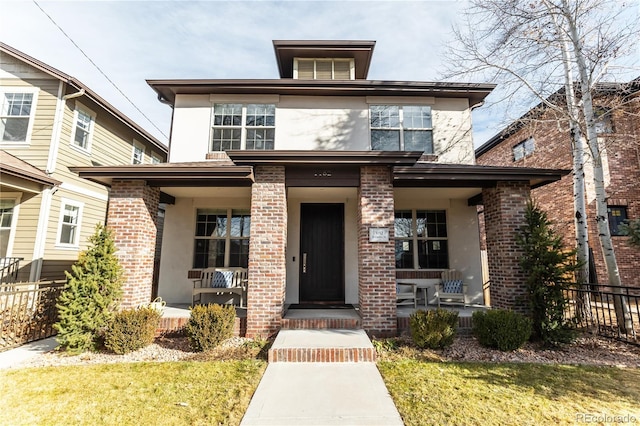 view of front of house featuring covered porch and a front yard