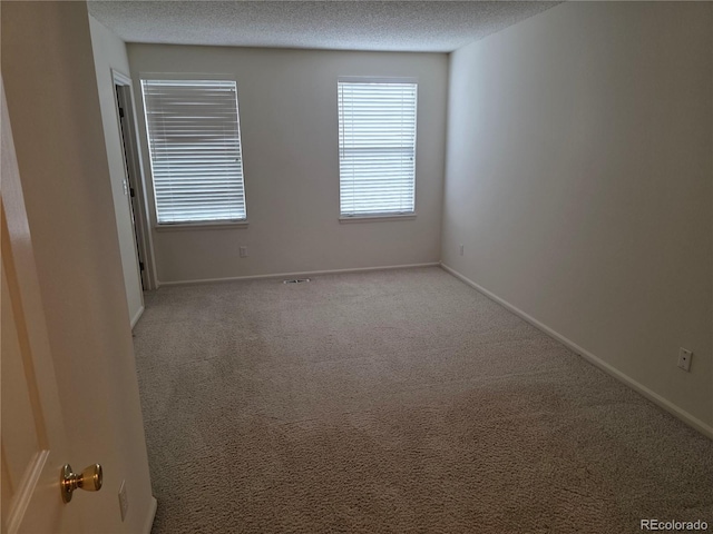 5741 W Asbury Pl, Lakewood, CO 80227 - carpeted empty room featuring a textured ceiling and baseboards