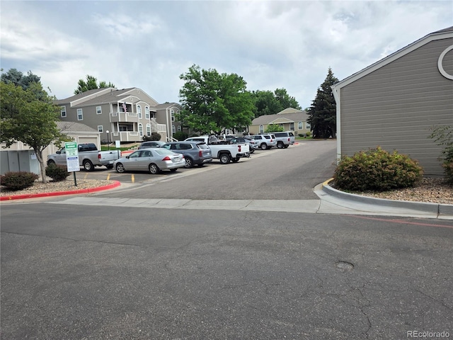 5741 W Asbury Pl, Lakewood, CO 80227 - uncovered parking lot featuring a residential view