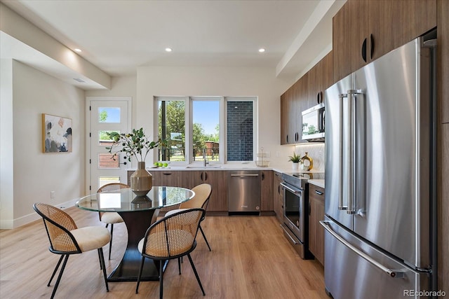 1372 Lowell Blvd Unit 1, Denver, CO 80204 - kitchen with appliances with stainless steel finishes, modern cabinets, light countertops, light wood-style floors, and recessed lighting