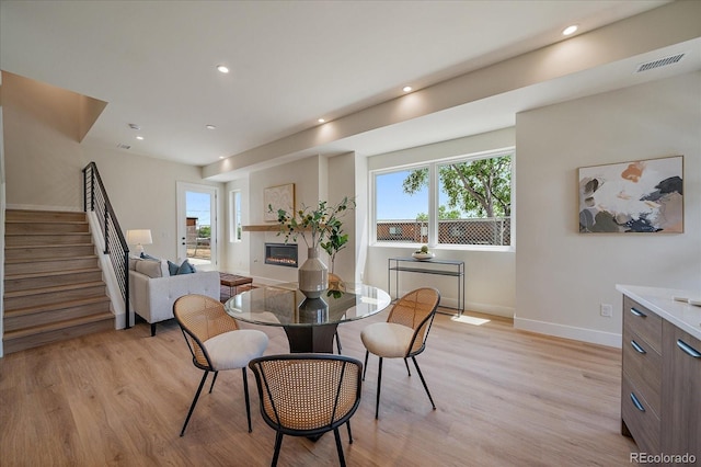 1372 Lowell Blvd Unit 1, Denver, CO 80204 - dining space featuring stairway, light wood-style flooring, recessed lighting, and baseboards